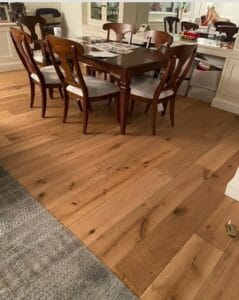 Dining room with hardwood flooring and a wooden dining table set.